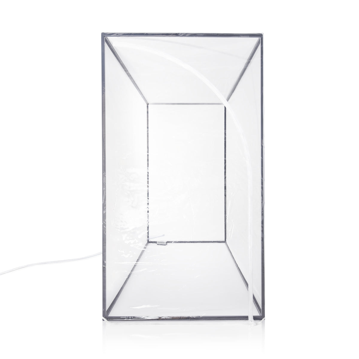 Empty enclosure shown end-on against white, clear walls over a slim dark frame with a lead running out